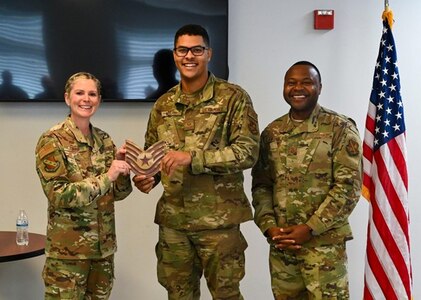 U.S. Air Force Col. Catherine “Cat” Logan, commander of Joint Base Anacostia-Bolling and the 11th Wing, and Chief Master Sgt. Clifford Lawton, senior enlisted leader of JBAB and command chief of the 11 WG, pose for a photo with Tech. Sgt. Brandon Miller, 11th Civil Engineer Squadron power production supervisor, after awarding him a Strips for Exceptional Performers promotion, Nov. 23, 2022, at JBAB, Washington D.C. The STEP program allows commanders an opportunity to immediately promote enlisted Airmen who exhibit exceptional potential beyond their rank. (U.S. Air Force photo by Airman Bill Guilliam)