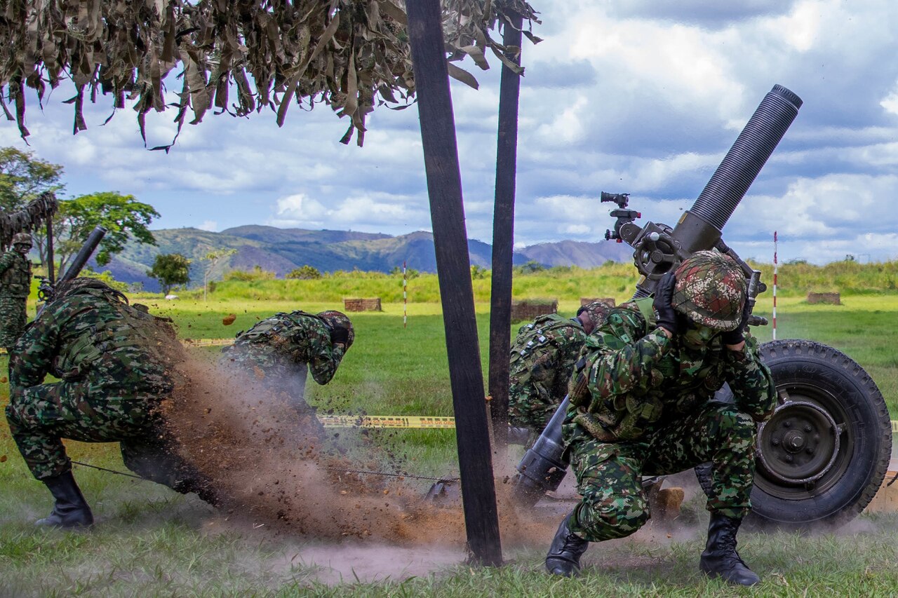 Soldiers fire a military weapon.