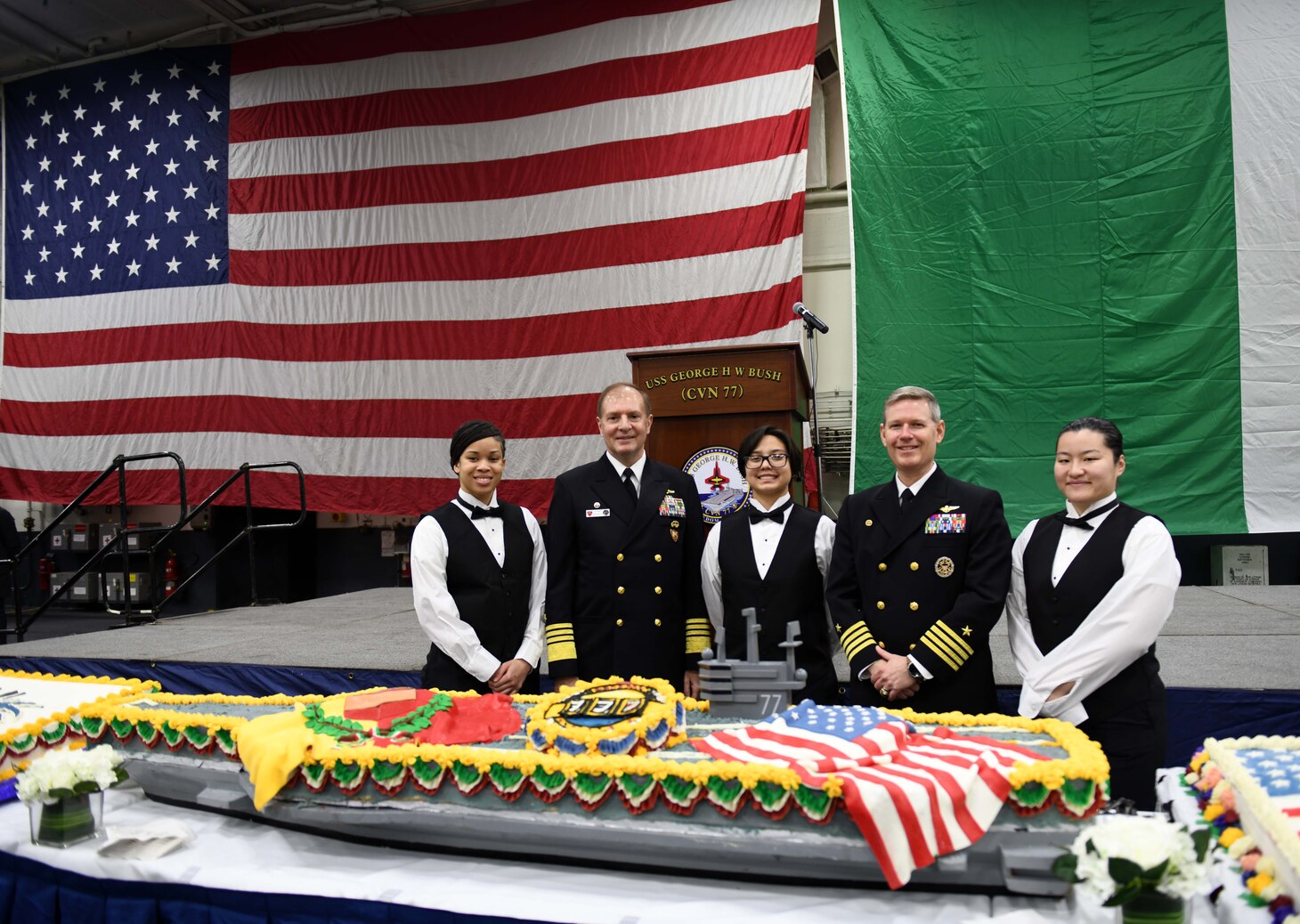 Culinary Specialists assigned to USS George H. W. Bush, pose for a photo with Adm. Stuart Munsch, Commander, U.S. Naval Forces Europe-Africa (NAVEUR-NAVAF) and Allied Joint Forces Command Naples, and Capt. Dave Pollard, Commanding Officer, George H. W. Bush, after a reception for local military and civilian leaders, honoring the U.S.–Italian relationship aboard the Nimitz-class aircraft carrier USS George H.W. Bush (CVN 77) during a scheduled port visit, Nov. 29, 2022.