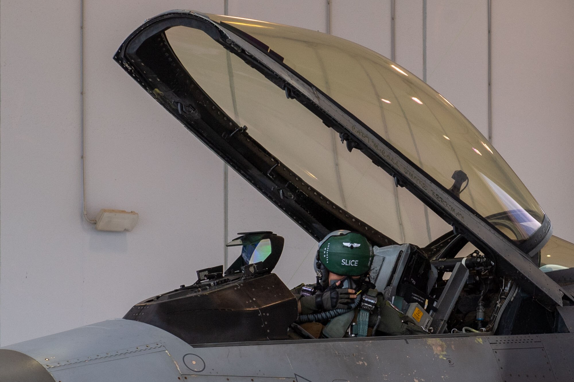 U.S. Air Force Capt. Kim “Slice” Auton, 555th FS F-16 pilot, lowers the canopy of an F-16 Fighting Falcon during exercise Falcon Strike 2022