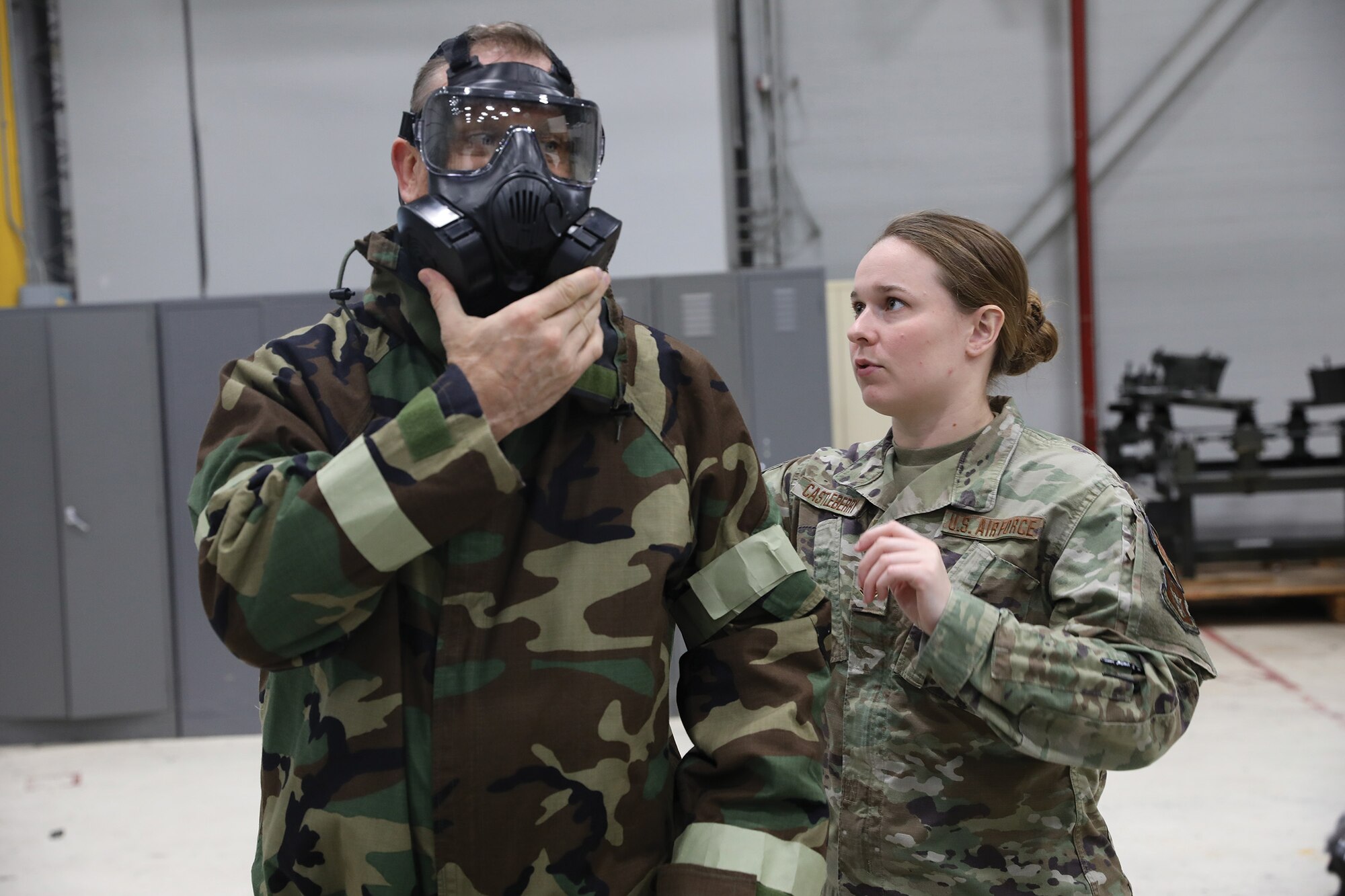 Staff Sgt. Chelsea Castleberry, 445th Civil Engineer Squadron emergency management apprentice, helps an employer don his Mission Oriented Protective Posture (M.O.P.P.) gear during the 445th Airlift Wing Employer Appreciation Day, Nov. 5, 2022. (U.S. Air Force photo/Senior Airman Angela Jackson)