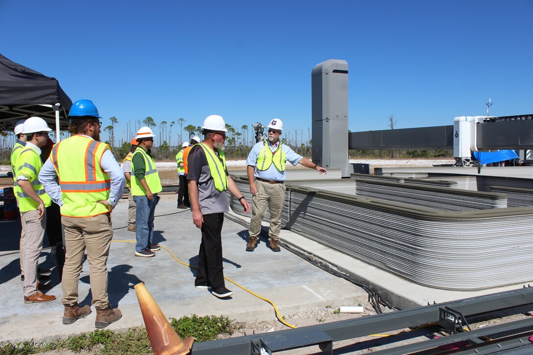 Civil engineers watching 3D printer