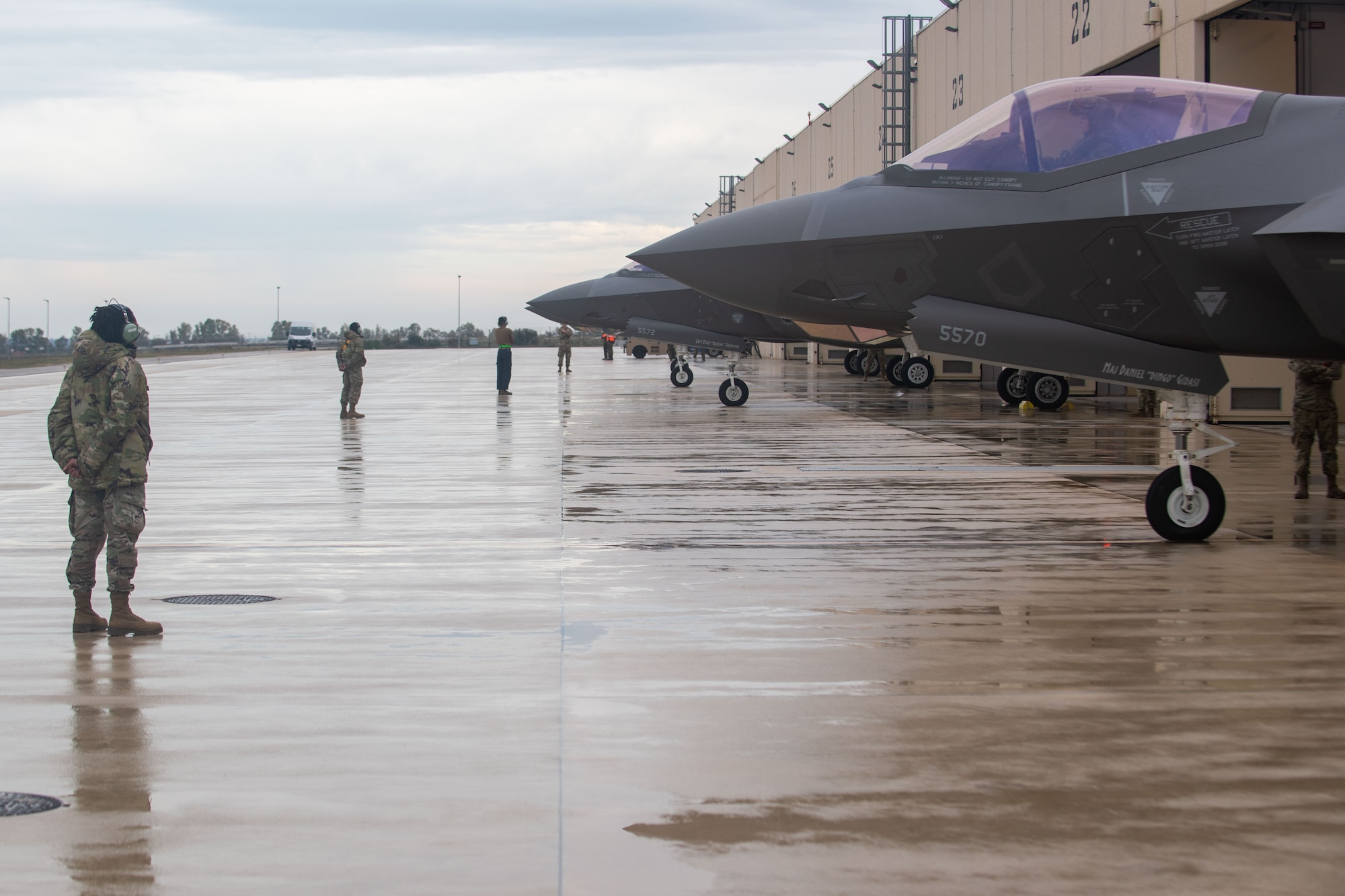 Senior Airman Chelsea Lewis, 493rd Aircraft Maintenance Unit crew chief, stands by with a U.S. Air Force F-35 Lightning II during exercise Falcon Strike 2022