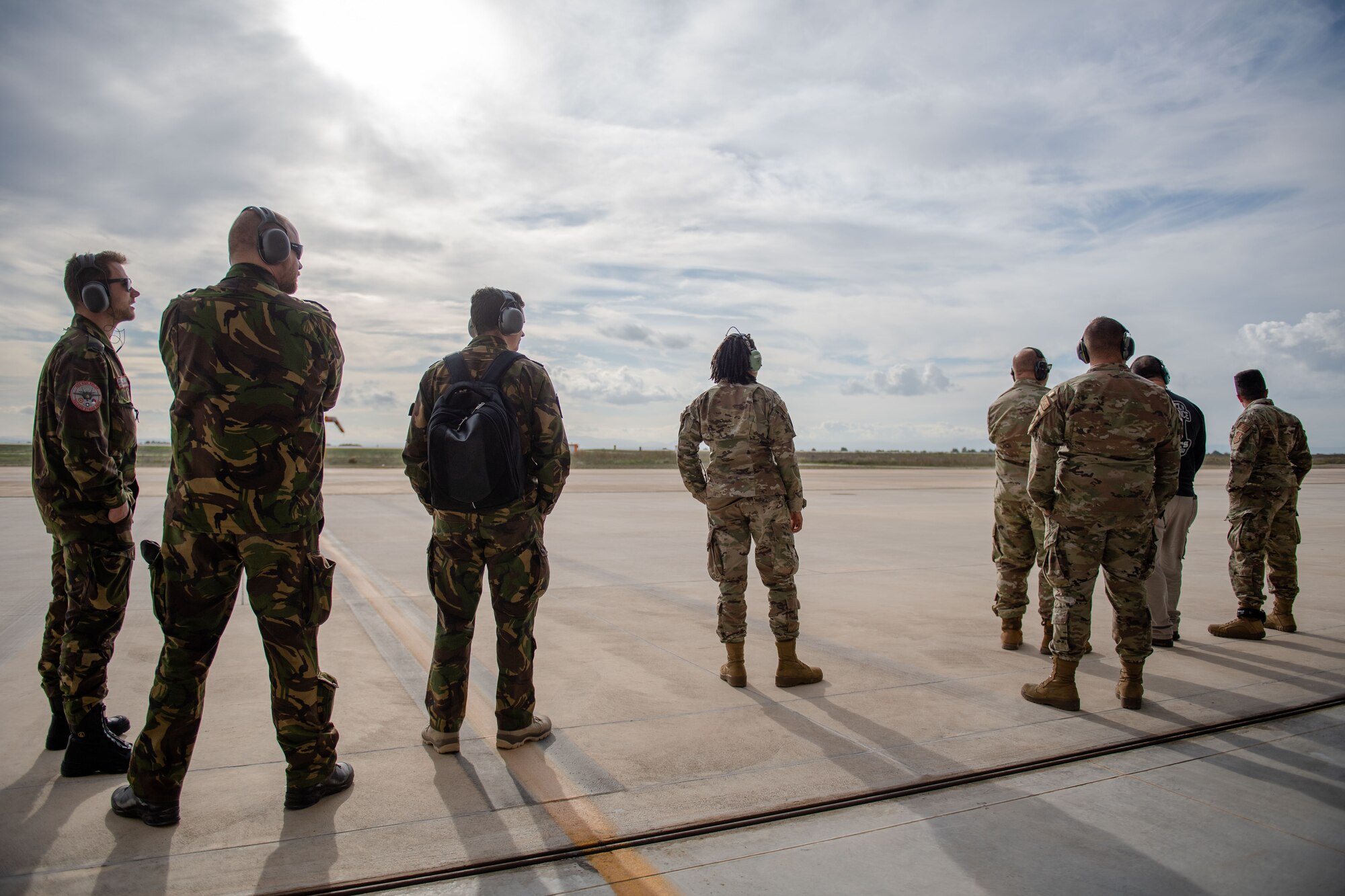 Members of the U.S. Air Force and Royal Netherlands air force watch aircraft take off at during exercise Falcon Strike 2022