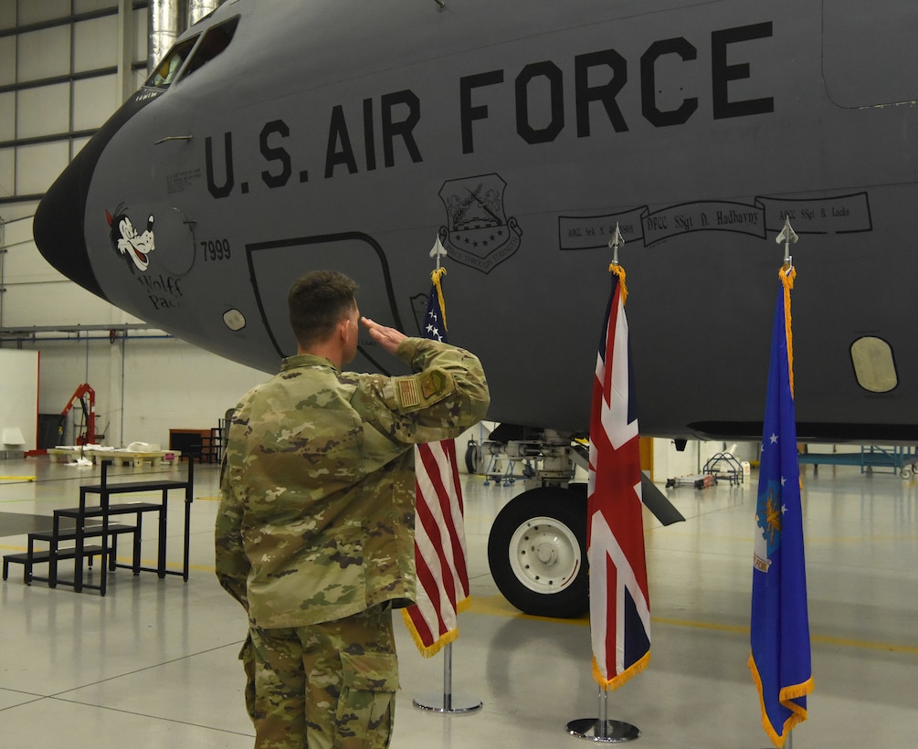 U.S. Air Force Col. David Hood, 100th Maintenance Group commander, gives a final salute to aircraft 7999, a KC-135 Stratotanker, during a retirement ceremony for the jet Nov. 23, 2022, at Royal Air Force Mildenhall, England. This was the first official retirement of a KC-135 at RAF Mildenhall. The 59-year-old tanker, which bears the World War II legacy nose art “Wolff Pack,” has taken its last flight and is now at its final resting place in “The Bone Yard” at Davis-Monthan Air Force Base, Arizona. (U.S. Air Force photo by Karen Abeyasekere)