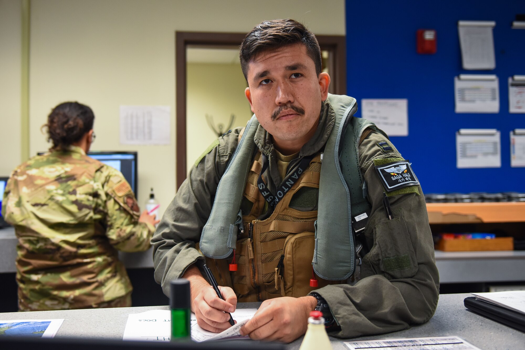U.S. Air Force Capt. Matthew Hale, 35th Fighter Squadron pilot, receives a briefing prior to a flight at Kunsan Air Base, Republic of Korea, Nov. 30, 2022. November is Native American Heritage Month and service members such as Hale make up less than 1% of the USAF. (U.S. Air Force photo by Tech Sgt. Timothy Dischinat)
