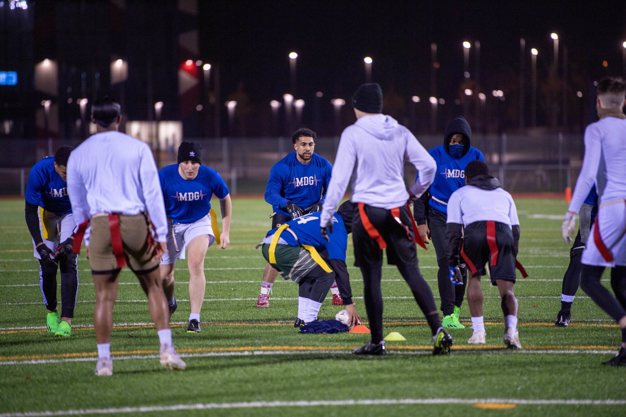 Flag football players play football