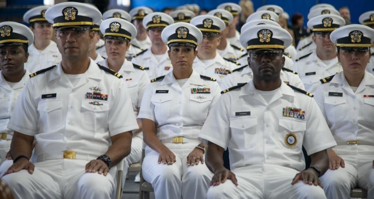 NEWPORT, RI. (Sept. 30, 2022) Officer Development School (ODS) class 22080 students at Officer Training Command Newport (OTCN), Rhode Island, sit at attention during their graduation ceremony, Sept. 30, 2022. ODS provides staff corps officers and several restricted line designators with training necessary to prepare them to function in their role as newly commissioned Naval officers. (U.S. Navy photo by Mass Communication Specialist 2nd Class Derien C. Luce)