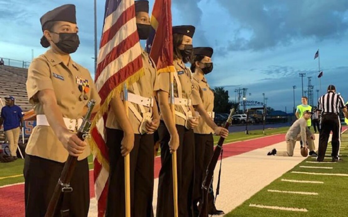 220916-N-NO450-9762 PASCAGOULA, Miss. – The Pascagoula High School Navy Junior Reserve Officers Training Corps Color Guard waits on the sideline to present the colors before a football game, September 16. The all-female color guard team is also all National Honor Society members. From left to right: Cadet Chief Petty Officer Kenairis Villanueva, Cadet First Class Petty Officer Kailyn Hyde, Cadet Lt. Haleiana Jones and Cadet Second Class Petty Officer Jasmine Webb. NJROTC and Navy National Defense Cadet Corps units operate at 583 high schools around the world with more than 78,000 cadets participating. The program is overseen by Naval Service Training Command headquartered on Naval Station Great Lakes, Ill. (Photo courtesy of Pascagoula High School NJROTC)