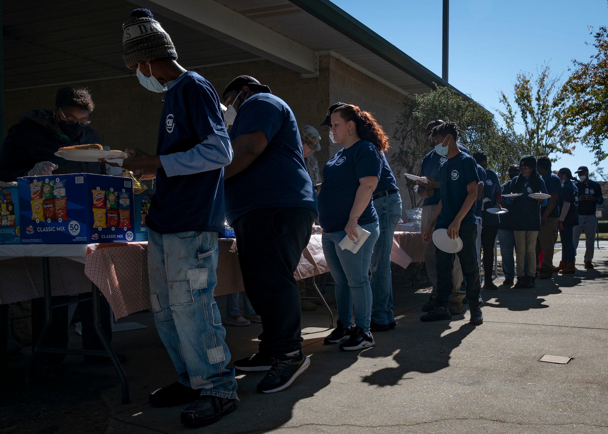 AbilityOne members stand in line for food at Shaw Air Force Base