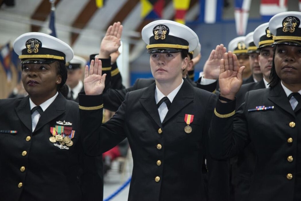 NEWPORT, RI. (Oct. 21, 2022) Officer Development School (ODS) class 22090 students at Officer Training Command Newport (OTCN), reaffirm the oath of office during their graduation ceremony, Oct. 21, 2022. ODS provides staff corps officers and several restricted line designators with training necessary to prepare them to function in their role as newly commissioned Naval officers. (U.S. Navy photo by Mass Communication Specialist 2nd Class Derien C. Luce)