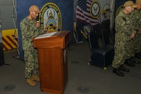 WALVIS BAY, Namibia (Nov. 25, 2022) U.S. Navy Sixth Fleet Chaplain, Lt. Ryan Khan, delivers the benediction during a change of command ceremony in the hangar bay of the expeditionary sea base USS Hershel "Woody" Williams (ESB 4) November 25, 2022. Hershel "Woody" Williams is on a scheduled deployment in the U.S. Naval Forces Africa area of operations, employed by U.S. Sixth Fleet to defend U.S., Allied and Partner interests. (U.S. Navy photo by Mass Communication Specialist 2nd Class Conner D. Blake/Released)