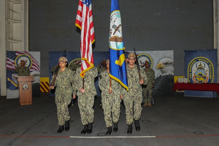 WALVIS BAY, Namibia (Nov. 25, 2022) U.S. Navy Honor Guard Sailors parade the colors during a change of command ceremony aboard the expeditionary sea base USS Hershel "Woody" Williams (ESB 4) November 25, 2022. Hershel "Woody" Williams is on a scheduled deployment in the U.S. Naval Forces Africa area of operations, employed by U.S. Sixth Fleet to defend U.S., Allied and Partner interests. (U.S. Navy photo by Mass Communication Specialist 2nd Class Conner D. Blake/Released)