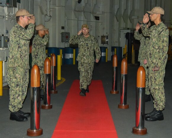 WALVIS BAY, Namibia (Nov. 25, 2022) Capt. Michael Concannon, former commanding officer of the expeditionary sea base USS Hershel "Woody" Williams (ESB 4), salutes the sideboys as he enters a change of command ceremony in the hangar bay November 25, 2022. Hershel "Woody" Williams is on a scheduled deployment in the U.S. Naval Forces Africa area of operations, employed by U.S. Sixth Fleet to defend U.S., Allied and Partner interests. (U.S. Navy photo by Mass Communication Specialist 2nd Class Conner D. Blake/Released)