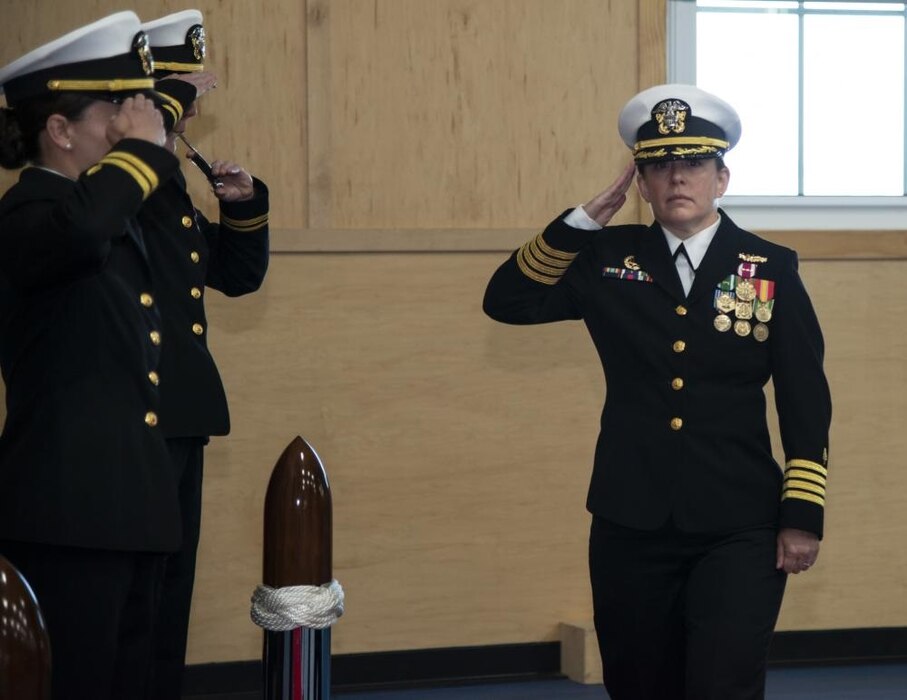 NEWPORT, RI (Oct. 21, 2022) Capt. Kristin Hodapp, commanding officer, Navy Medicine Readiness and Training Command, passes through sideboys during the Officer Development School (ODS) class 22090 graduation ceremony at Officer Training Command Newport (OTCN), Rhode Island, Oct. 21, 2022. ODS provides staff corps officers and several restricted line designators with training necessary to prepare them to function in their role as newly commissioned Naval officers. (U.S. Navy photo by Mass Communication Specialist 2nd Class Derien C. Luce)