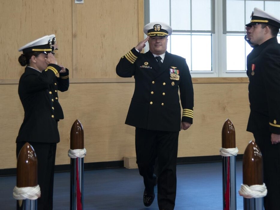 NEWPORT, RI (Oct. 21, 2022) Capt. Everett Alcorn, commanding officer, Officer Training Command Newport (OTCN), Rhode Island, passes through sideboys during the Officer Development School (ODS) class 22090 graduation ceremony, Oct. 21, 2022. ODS provides staff corps officers and several restricted line designators with training necessary to prepare them to function in their role as newly commissioned Naval officers. (U.S. Navy photo by Mass Communication Specialist 2nd Class Derien C. Luce)
