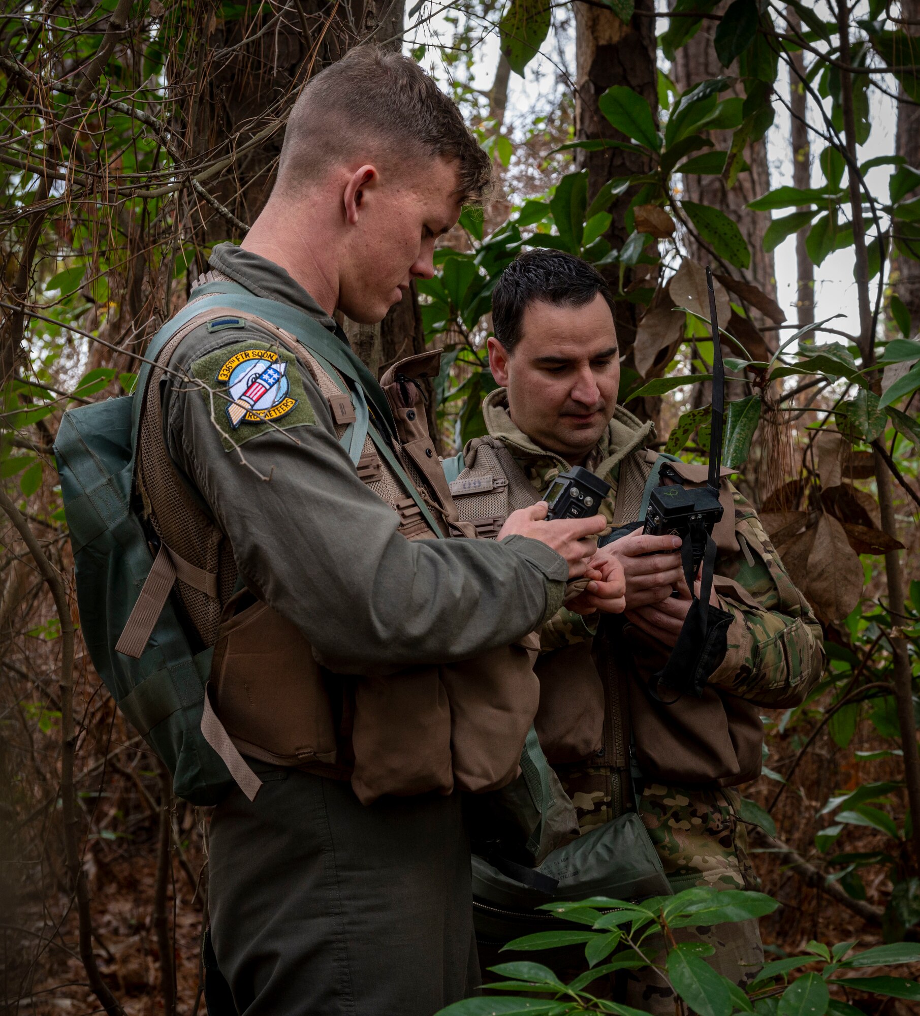 1st Lt. Benjamin Vansant (left), 336th Fighter Squadron F-15E Strike Eagle pilot, and Major Richard Benkovics, 336th FS weapon system officer, begin Survival, Evasion, Resistance and Escape training by simulating a scenario of landing in enemy territory at Seymour Johnson Air Force Base, North Carolina, Nov. 16, 2022. SERE instructors conduct operations around the world preparing aircrew personnel to return from any type of survival situation. (U.S. Air Force photo by Airman 1st Class Sabrina Fuller)