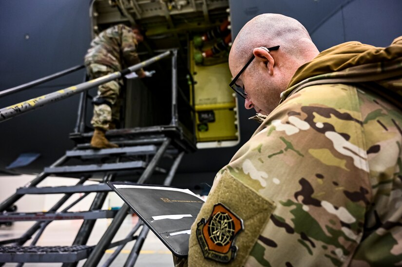 U.S. Air Force Master Sgt. Johnathan Ferguson, 305th Air Mobility Wing quality assurance inspector (Right), and U.S. Air Force Tech. Sgt. Chase Staron, 305th Air Mobility Wing crew chief (Left), perform a quality assurance inspection at Joint Base McGuire-Dix-Lakehurst, N.J. on Nov. 22, 2022. Ferguson is one of over one million registered bone marrow donors through the Department of Defense’s Salute to Life program. This year he met with the recipient of a donation he made in 2012 that allowed the patient to achieve remission of leukemia.