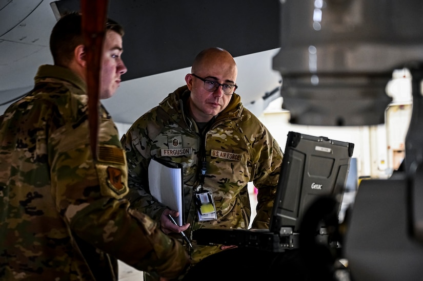 U.S. Air Force Master Sgt. Johnathan Ferguson, 305th Air Mobility Wing quality assurance inspector (Right), and U.S. Air Force Tech. Sgt. Chase Staron, 305th Air Mobility Wing crew chief, perform a quality assurance inspection at Joint Base McGuire-Dix-Lakehurst, N.J. on Nov. 22, 2022. Ferguson is one of over one million registered bone marrow donors through the Department of Defense’s Salute to Life program. This year he met with the recipient of a donation he made in 2012 that allowed the patient to achieve remission of leukemia.