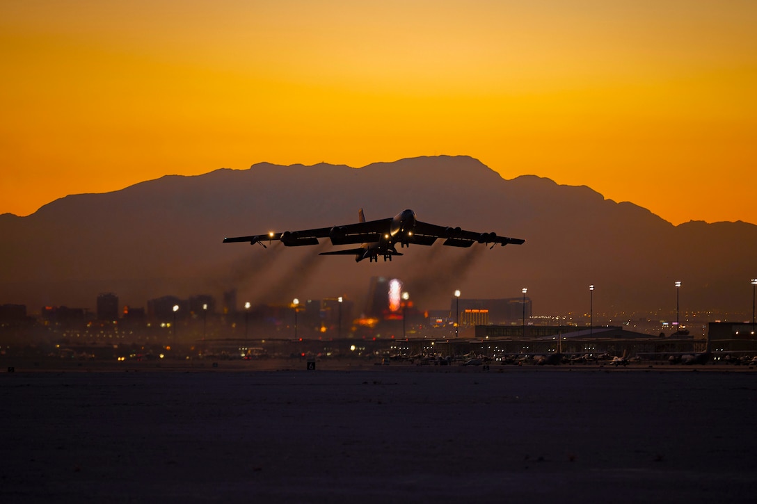 An aircraft takes off from a tarmac under a sunlit sky.