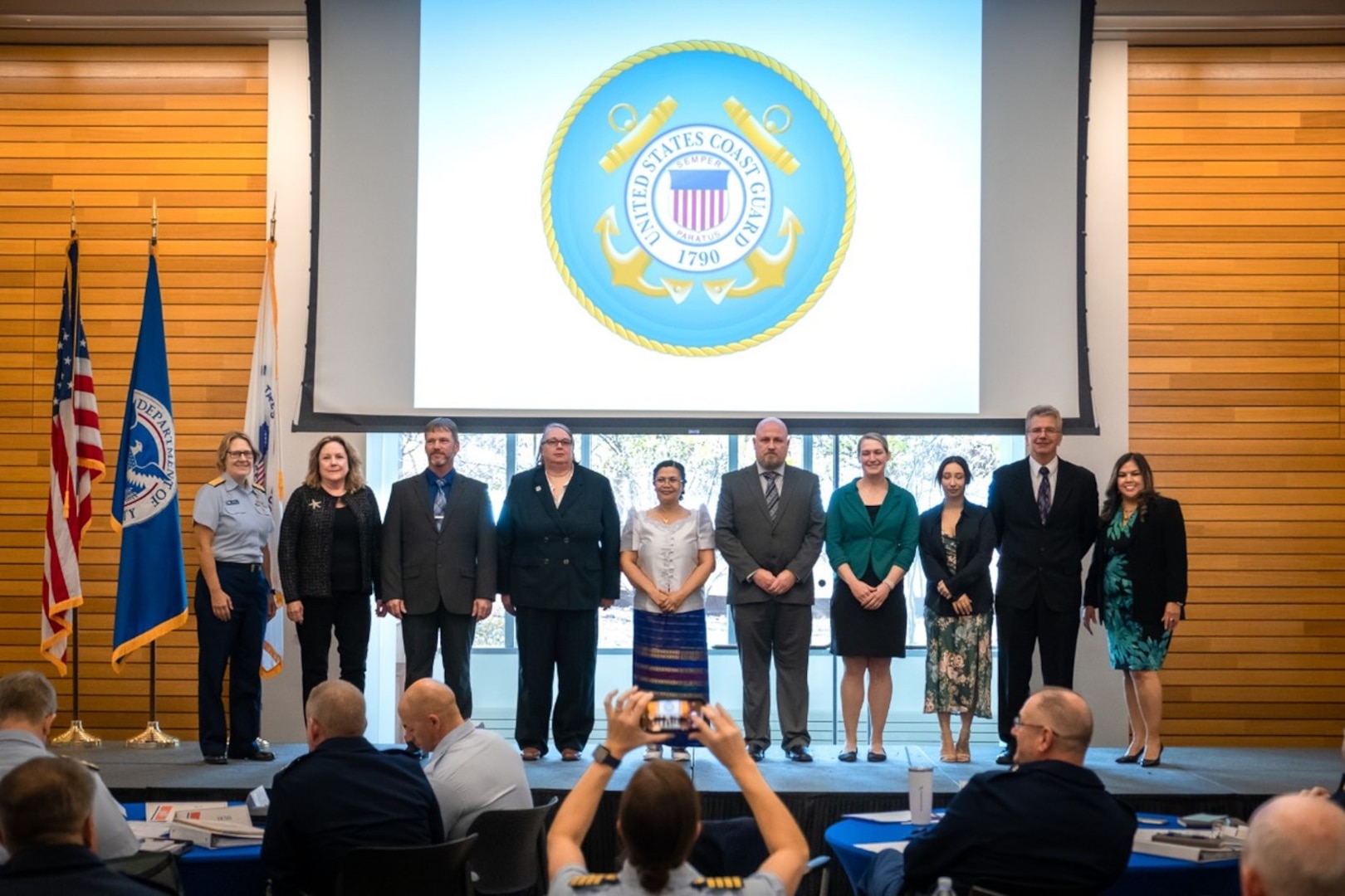 Coast Guard Commandant Admiral Linda L. Fagan and the 2021 Civilian Employee of the Year Award winners onstage during the award ceremony held at Coast Guard Headquarters, Washington, D.C., Nov. 17, 2022 (U.S. Coast Guard photo).