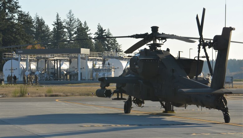An AH-64 Apache helicopter sits on one of three, hot-fueling pads in front of the new airfield refueling facility on Gray Army Airfield at Joint Base Lewis-McChord Nov. 17. (Bud McKay, Joint Base Lewis-McChord Public Affairs)