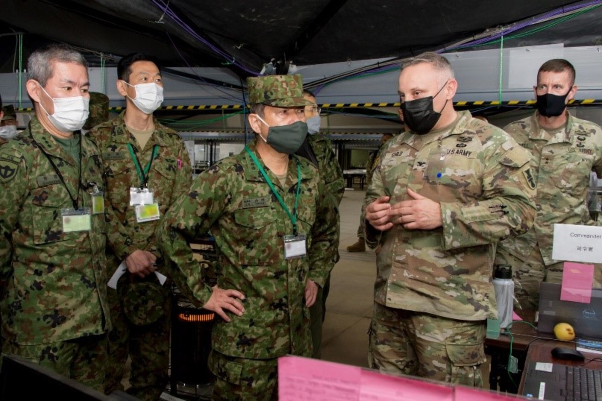 Col. Michael Child briefs the Japanese Chief of Staff, Joint Staff (escorted by Maj. Gen. Vowell - Commander of U.S. Army Reserve - Japan) on the DLD's capabilities and integration with Japan's Middle Army at Yama Sukura 81 in Dec 2021. Photo by Lt. Col. Daniel Powell, 206th Digital Liaison Detachment Operations Chief