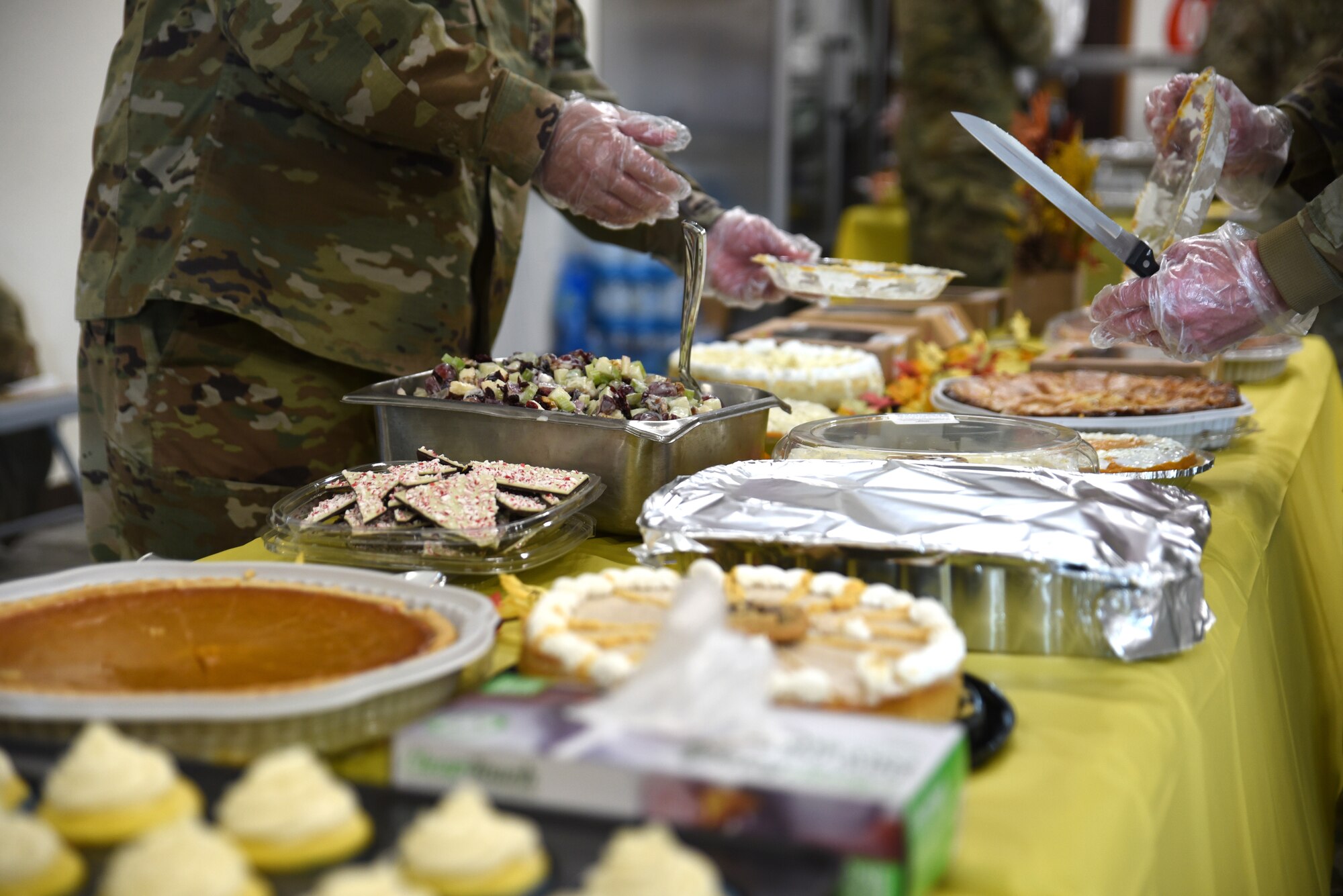 Team McChord first sergeants serve a variety of food and desserts at the Dormsgiving Extravaganza at Joint Base Lewis-McChord, Washington, Nov. 17, 2022. Team McChord first sergeants hosted this event as a way to thank Airmen for their hard work and dedication to Team McChord. (U.S. Air Force photo by Airman Kylee Tyus)
