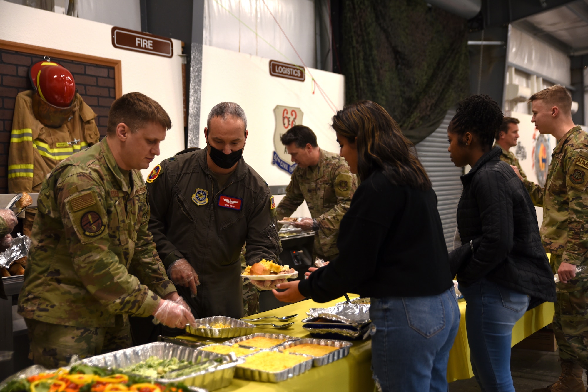U.S. Air Force Team McChord first sergeants and other leadership serve a variety of food during the Dormsgiving Extravaganza at Joint Base Lewis-McChord, Washington, Nov. 17, 2022. Team McChord first sergeants hosted this event as a way to thank Airmen for their hard work and dedication to Team McChord. (U.S. Air Force photo by Airman Kylee Tyus)