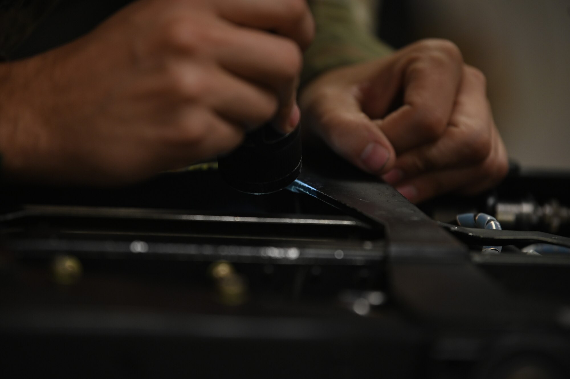 Airmen assigned to the 4th Component Maintenance Squadron inspect components of an eject seat at Seymour Johnson Air Force Base, North Carolina, Nov. 8, 2022. Egress Airmen inspect eject seats to ensure each component is properly placed and secured prior to being installed into the aircraft. (U.S. Air Force photo by Airman 1st Class Rebecca Sirimarco-Lang)