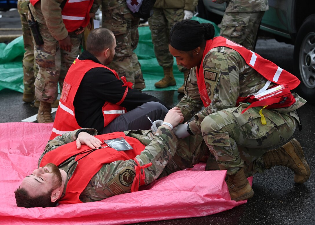 A 316th Medical Group Airman helps perform emergency care on a victim during an active shooter exercise at Joint Base Andrews, Md., Nov. 30, 2022. Airmen involved in the exercise were evaluated on their actions, such as how they communicated with one another, tracked down the target(s) and attempted to save lives. (U.S. Air Force photo by Airman 1st Class Austin Pate)