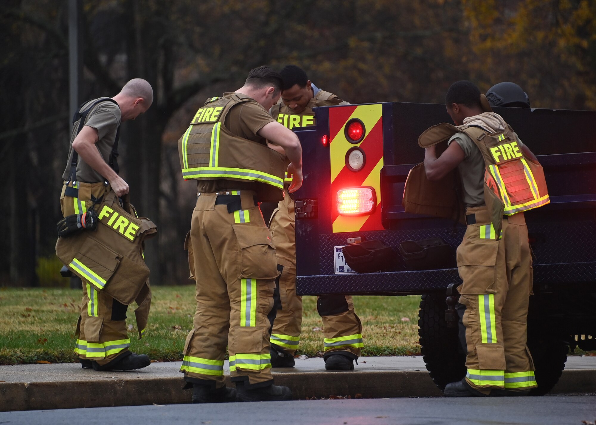 Standing by their vehicle, 316th Wing Civil Engineer Squadron Airmen put on gear in preparation for an active shooter exercise at Joint Base Andrews, Md., Nov. 30, 2022. These types of exercises are typically executed four times a year at JBA to determine if installation personnel and plans are ready for wartime and deployed scenarios. (U.S. Air Force photo by Airman 1st Class Austin Pate)