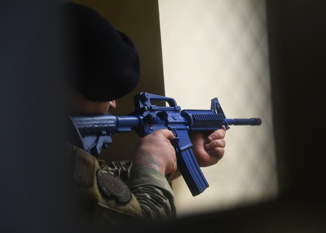 A 316th Security Forces Squadron Airman aims his training weapon during an active shooter exercise at Joint Base Andrews, Md., Nov. 30, 2022. Airmen involved in the exercise were evaluated on their actions, such as how they communicated with one another, tracked down the target(s) and attempted to save lives. (U.S. Air Force photo by Airman 1st Class Austin Pate)