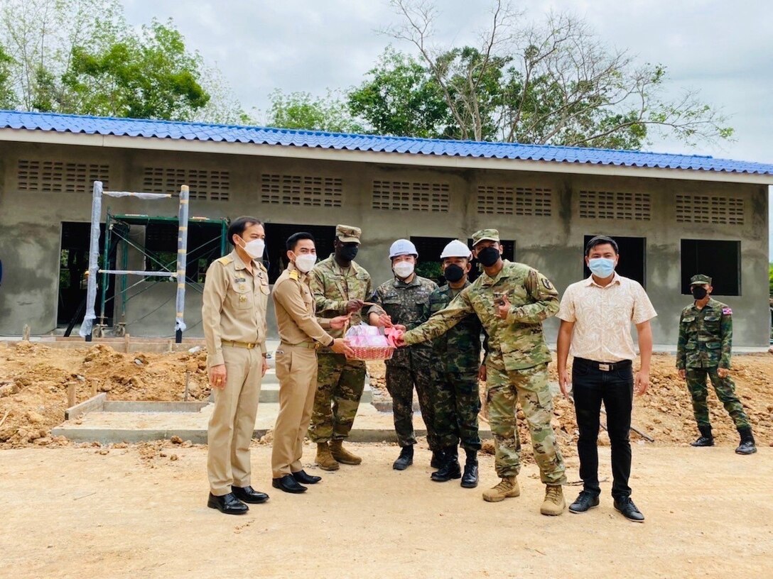 Engineer partners with the U.S. Army Reserve, the Royal Thai Navy, and the Republic of Korea Navy stand together after building a new annex to the Ban Khao Ta-In School in the Rayong Province of the Kingdom of Thailand, Feb. 28, 2022, as part of Cobra Gold 2022. CG 22 is the 41st iteration of the international training exercise that supports readiness and emphasizes coordination on civic action, humanitarian assistance, and disaster relief. From Feb. 22 through March 4, 2022, this annual event taking place at various locations throughout the Kingdom of Thailand increases the capability, capacity, and interoperability of partnered nations while simultaneously reinforcing our commitment to a free and open Indo-Pacific. (U.S. Army Reserve Photo by 1st Lt. Apisit Meejaiyen)