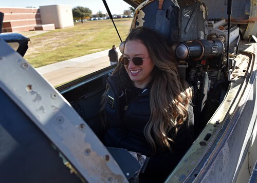 Halle McCrory, 17th Training Wing, honorary commander, sits in the cockpit of the MiG-29 trainer at Goodfellow Air Force Base, Texas, Nov. 30, 2022. The MiG-29 is a Soviet era twin-engine fighter aircraft and is used to enhance training on base. (U.S. Air Force photo Airman 1st Class Zachary Heimbuch)