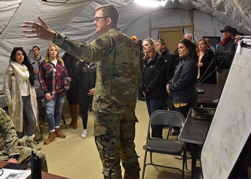 17th Training Wing honorary commanders are briefed on the mission of Forward Operating Base Sentinel, Goodfellow Air Force Base, Texas, Nov. 30, 2022. FOB Sentinel is a simulated combat environment operated by the cadre of the 344th Military Intelligence Battalion as a capstone exercise for their students. (U.S. Air Force photo by Airman 1st Class Zachary Heimbuch)