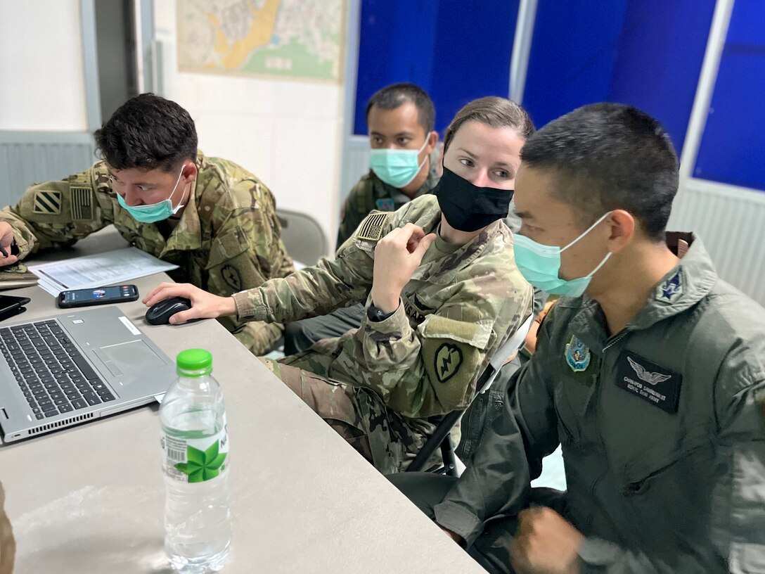 1st Lt. Nicole Chrzanowski (center) and Capt. Frank Fink (left), aviators with 2nd Battalion, 25th Aviation Regiment, 25th Combat Aviation Brigade, 25th Infantry Division, and their counterparts with the Royal Thai Army conduct air assault mission planning Mar 3, 2022 as part of Exercise Cobra Gold 2022 in the Lopburi Province of the Kingdom of Thailand. CG 22 is the 41st iteration of the international training exercise that supports readiness and emphasizes coordination on civic action, humanitarian assistance, and disaster relief. From Feb. 22 through March 4, 2022, this annual event taking place at various locations throughout the Kingdom of Thailand increases the capability, capacity, and interoperability of partnered nations while simultaneously reinforcing our commitment to a free and open Indo-Pacific. (U.S. Army photo by 1st Lt. Jason Palauskas)