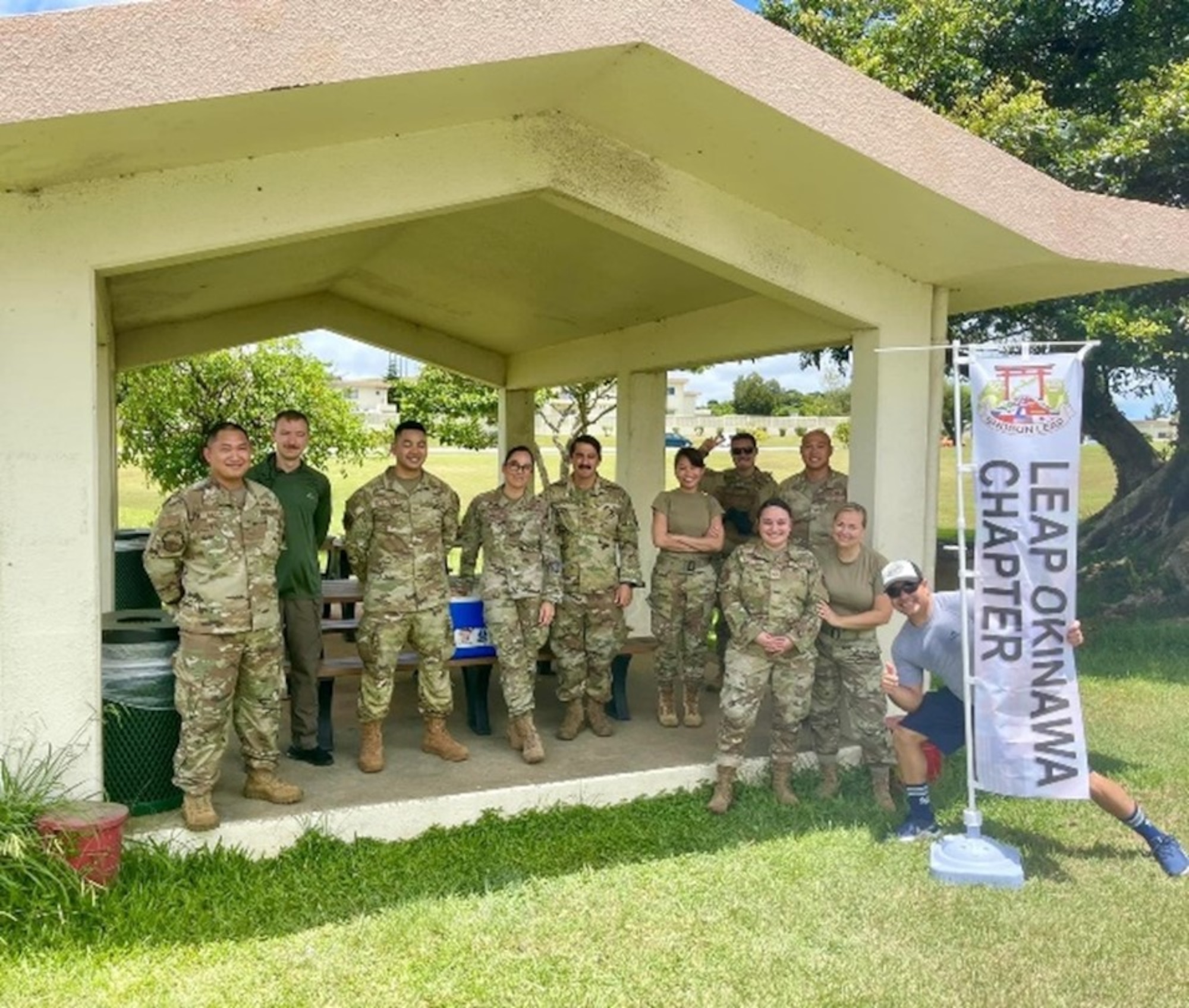 Airmen standing behind a "LEAP Okinawa Chapter" banner