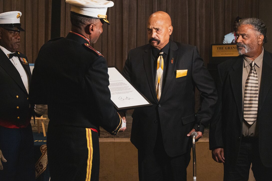 Anthony Smith and his family accept the Congressional Gold Medal on behalf of his father during the U.S. Marine Corps Birthday Ball celebration with the National Montford Point Marine Association, Chapter 8 in Los Angeles, California on Nov. 19, 2022. Montford Point Marines are the first black Marines to enlist in the U.S. Marine Corps and carry their extraordinary legacy of resilience, grit and honor. (U.S. Marine Corps photo by Sgt. Emely Gonzalez)