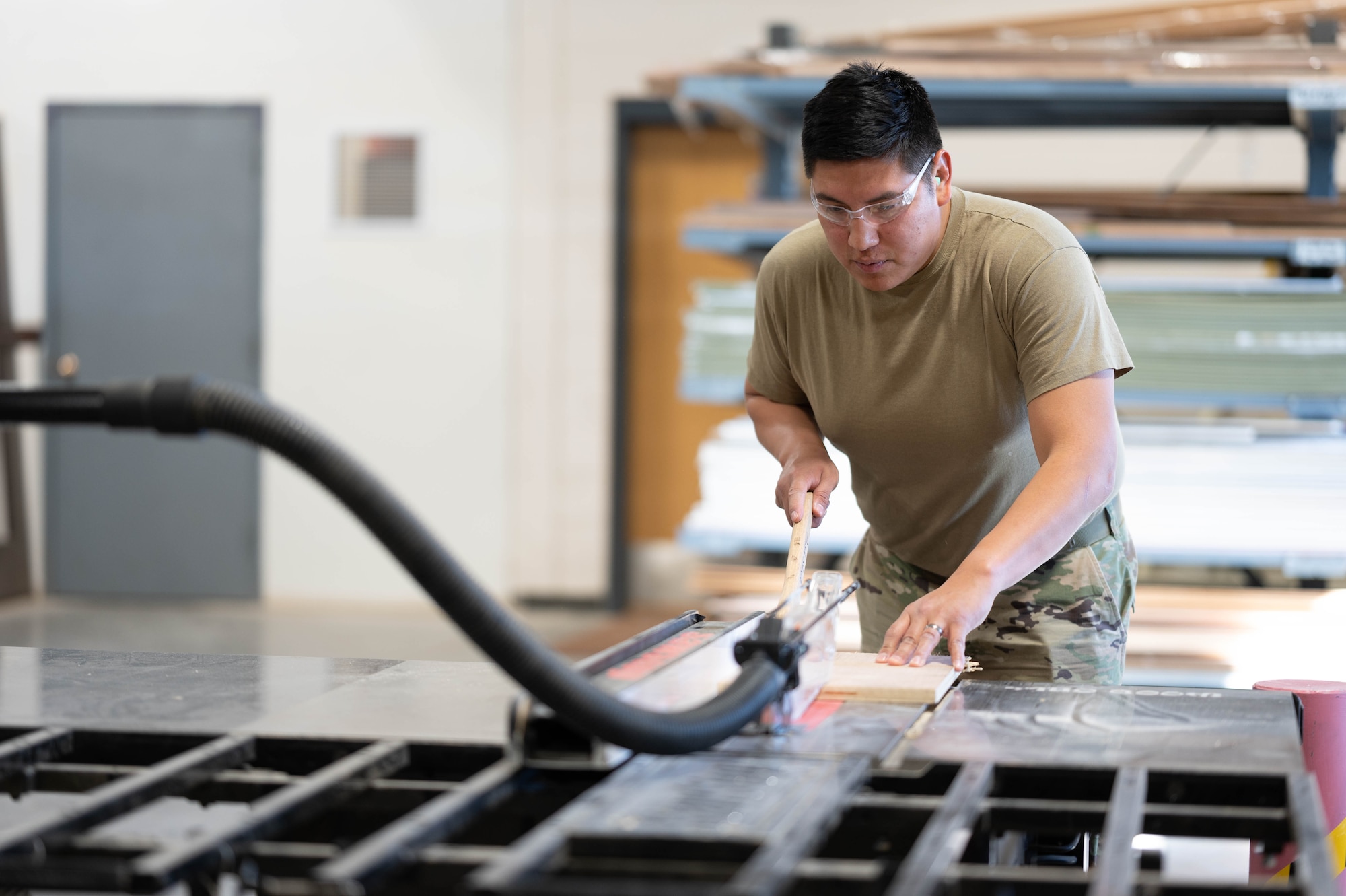 Senior Airman Aaron LeClair, 28th Civil Engineer Squadron structural journeyman, cuts pieces of wood Nov. 30, 2022, at Ellsworth Air Force Base, S.D. LeClair is very proud of his Native American background and enjoys sharing his culture. (U.S. Air Force photo by Staff Sgt. Alexi Bosarge)