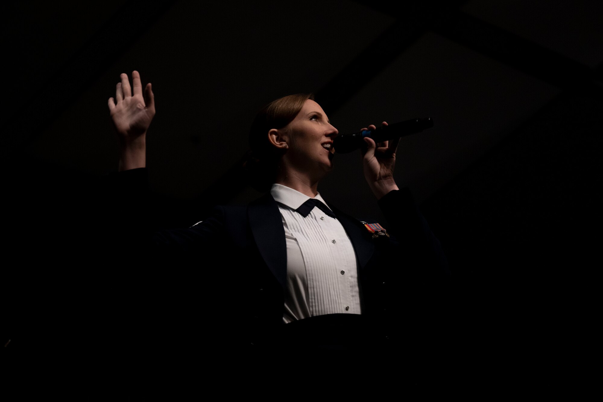 Staff Sgt. Rachael Colman, United States Air Force Heritage of America Band vocalist, sings during a Veteran’s Day concert at Edgecombe Community College in Tarboro, North Carolina, Nov. 9, 2022. In partnership with the Air Force Recruiting Service, the band performs for events that generate interest and enthusiasm for military service. (U.S. Air Force photo by Senior Airman Kevin Holloway)