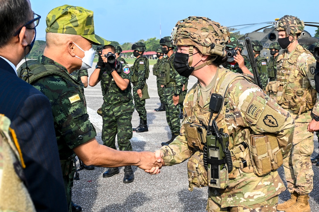 Gen. Narongpan Jitkaewthae, the commander-in-chief of the Royal Thai Army, congratulates Army Capt. Monday Price, commander of Headquarters and Headquarters Company, 29th Brigade Engineer Battalion, for showing leadership during the opening ceremony of Hanuman Guardian 2022 at the Infantry Center, Khao Noi, Kingdom of Thailand, Feb. 24, 2022. Hanuman Guardian 2022 is the 11th iteration of the annual bilateral U.S. Army Pacific Theater Security Cooperation Program event conducted with the Royal Thai Army in coordination with United States Indo-Pacific Command. As part of the Pacific Pathways series, the goal of HG22 is to foster closer relationships, increase readiness, and enhance interoperability among service members of the U.S. Army and Royal Thai Army. (U.S. Army photo by Danielle O'Donnell)