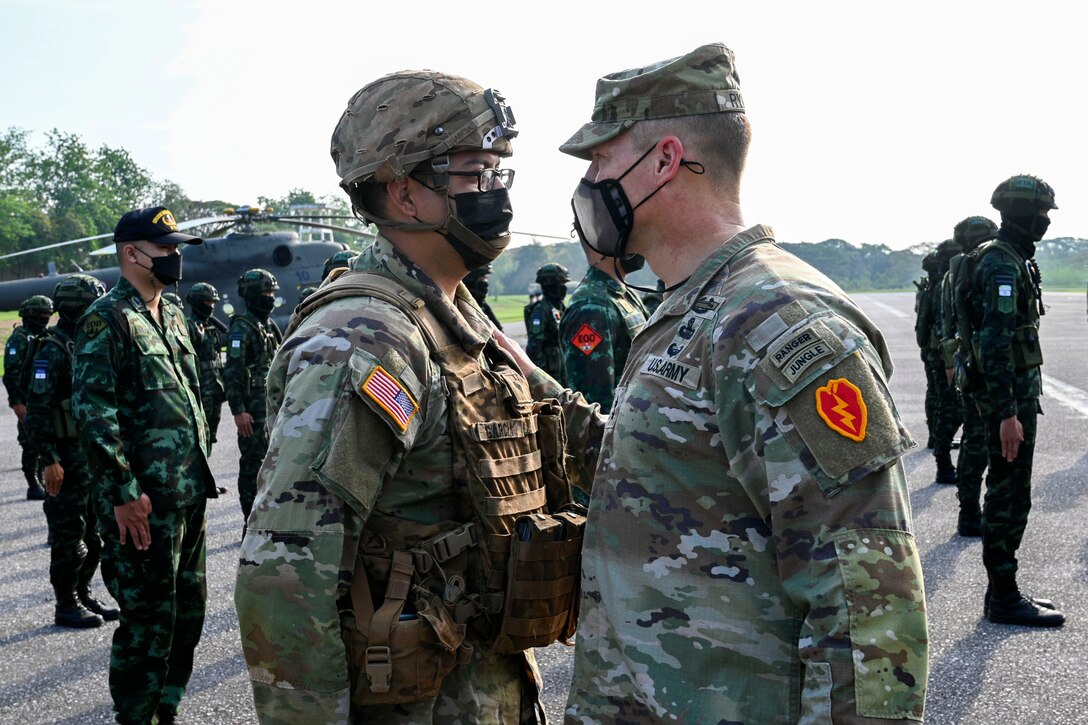 Army Maj. Gen. Joseph Ryan, the commanding general of the 25th Infantry Division, inspects a U.S. Soldier assigned to the 25th Infantry Division during the opening ceremony for Hanuman Guardian 2022 at the Infantry Center, Khao Noi, Kingdom of Thailand, Feb. 24, 2022. Hanuman Guardian 2022 is the 11th iteration of the annual bilateral U.S. Army Pacific Theater Security Cooperation Program event conducted with the Royal Thai Army in coordination with United States Indo-Pacific Command. As part of the Pacific Pathways series, the goal of HG22 is to foster closer relationships, increase readiness, and enhance interoperability among service members of the U.S. Army and Royal Thai Army. (U.S. Army photo by Danielle O'Donnell)