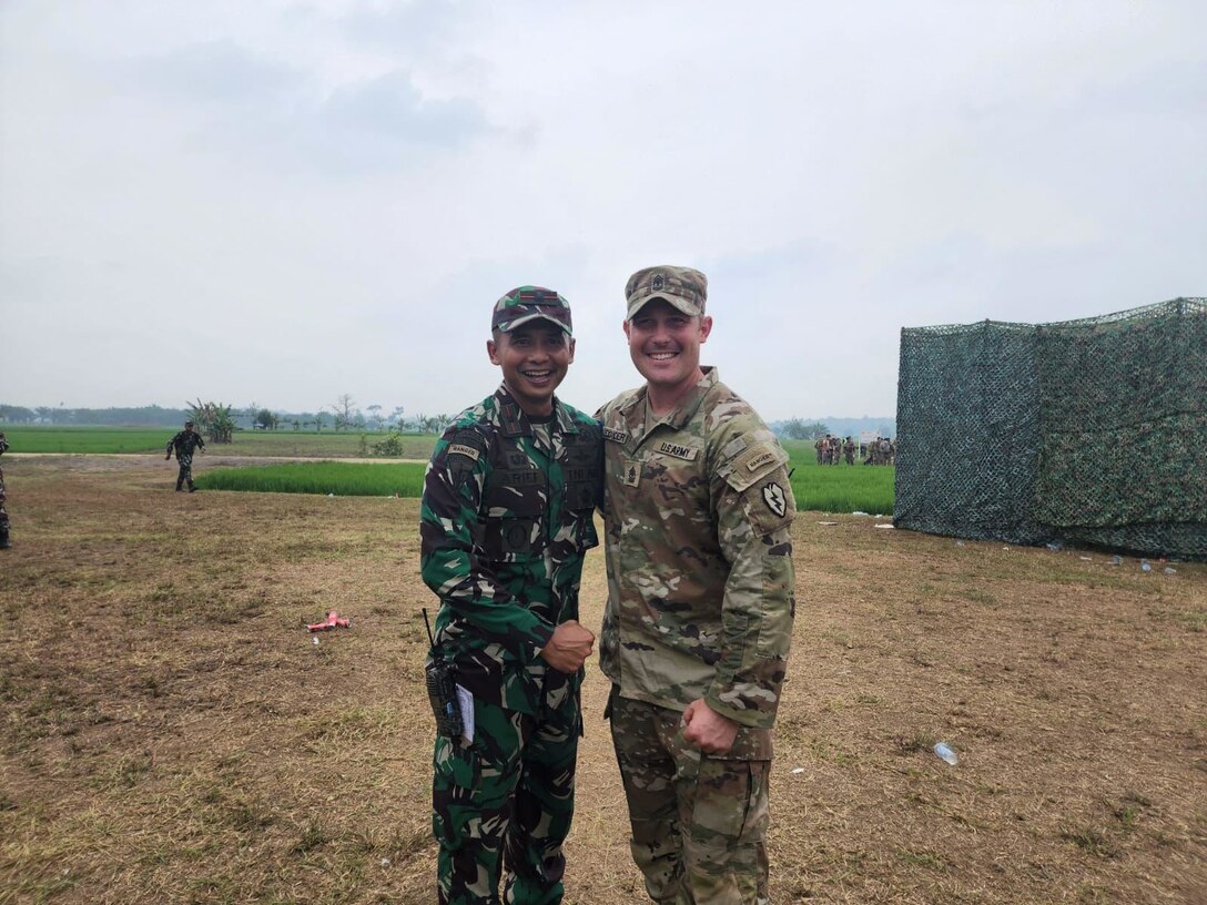 Maj. Arief Widyanto, Tentara Nasional Indonesia (TNI) poses for a photo after reuniting with his former Ranger Instructor, 1st Sgt. Dan Alexander during Super Garuda Shield in Bataraja, Indonesia on Aug. 3, 2022. Super Garuda Shield, a part of Operation Pathways and a longstanding annual, bilateral military exercise conducted between the U.S. military and Indonesia National Armed Forces, reinforces the U.S. commitments to our allies, and regional partners, joint readiness, and the interoperability to fight and win together. (Maj. Jonathan Daniell, 25th Infantry Division)