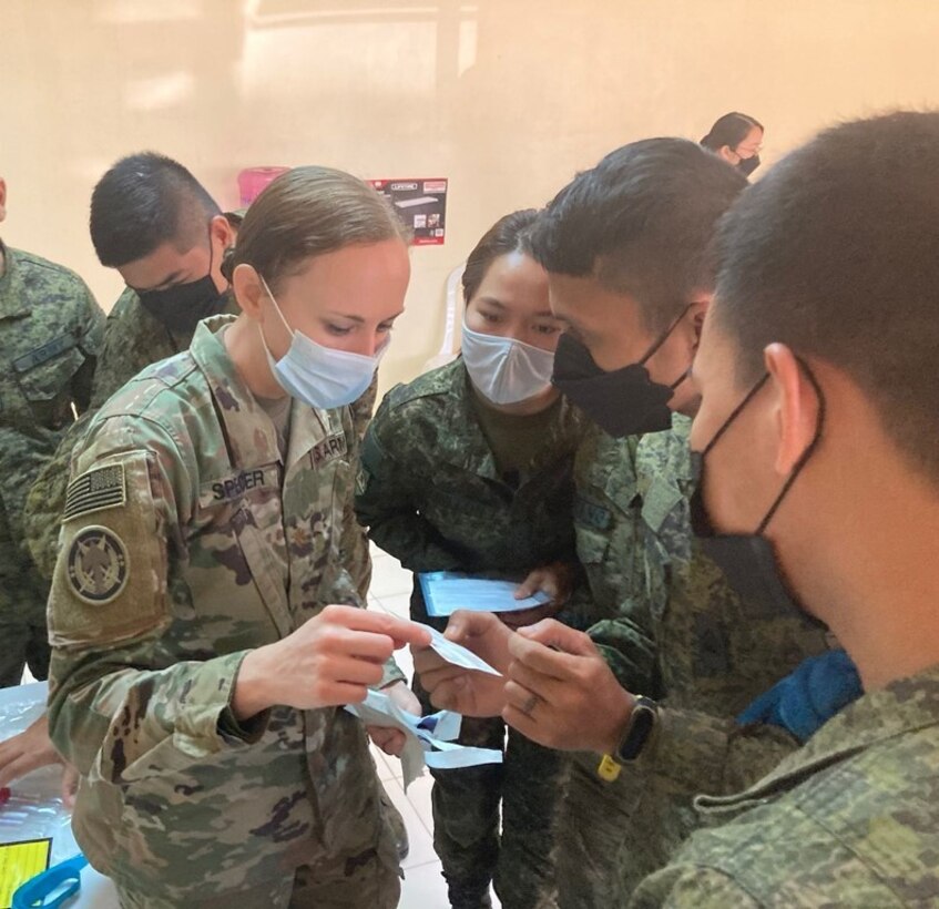 Maj. Kelly Spencer, 5th Security Force Assistance Brigade Nurse and Medical Advisor, discusses the use of Eldon blood-typing cards with medics and nurses from the Philippine Army. The hands-on training was part of a class on fresh whole blood transfusion at the point of injury during Salaknib '22 at Fort Magsaysay, Philippines, Mar. 14, 2022.
