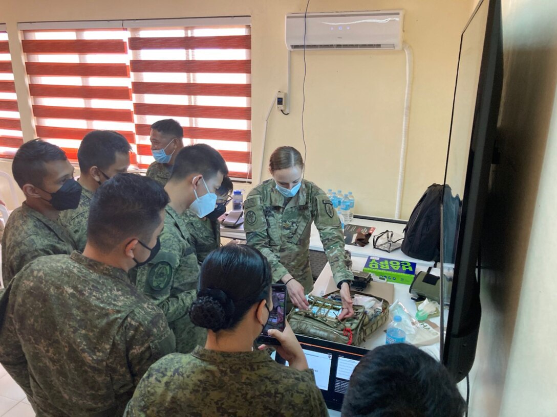 The 5th Security Force Assistance Brigade Nurse, Maj. Kelly Spencer demonstrates medical aid bag packing for members of the Philippine Army at Fort Magsaysay, Philippines, Mar. 14, 2022. This portion of the bilateral training between 5th SFAB Medical Advisors and the Philippine Army emphasized Tactical Combat Casualty Care best practices during Salaknib '22.