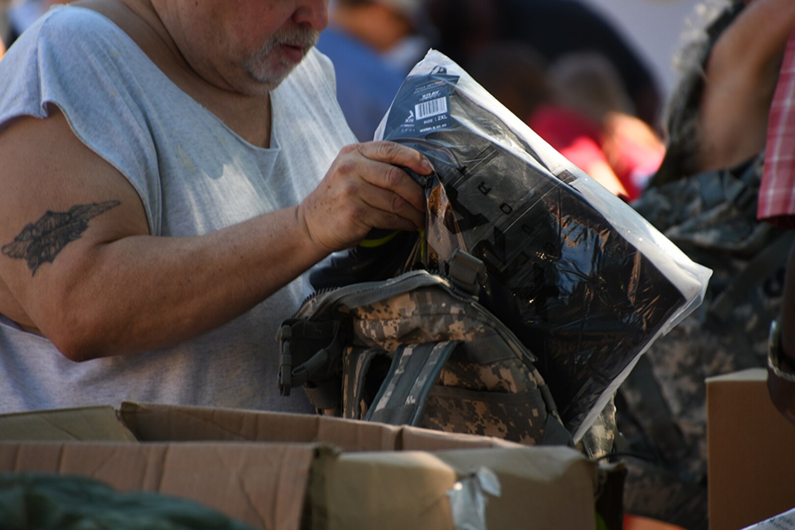 A man looks at surplus clothing.