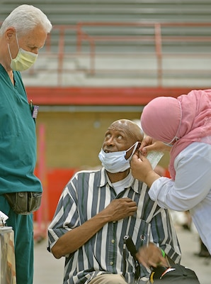 A man gets his ears checked by doctors.
