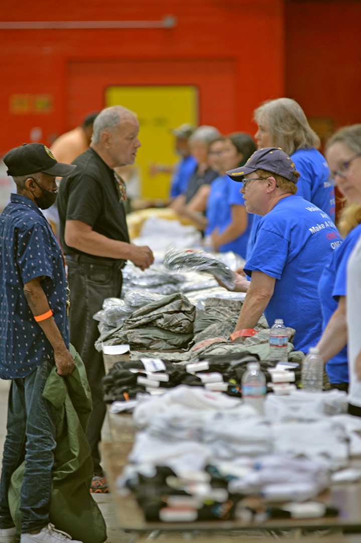 A veteran talks with a volunteer about free clothing.