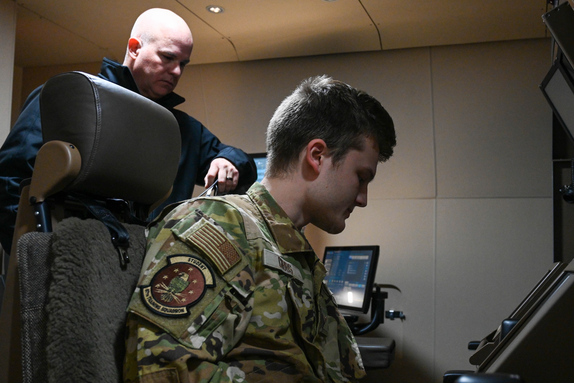 Airman 1st Class Luke Gibbs (right), 97th Training Squadron boom operator student, goes through a preflight checklist in the simulator, while Mike Morris, KC-46 Pegasus boom operator instructor, observes at Altus Air Force Base, Oklahoma, Nov. 29, 2022. The three phases of KC-46 pilot and boom operator training are focused on developing students who know nothing about the KC-46 to eventually operate it. (U.S. Air Force photo by Senior Airman Trenton Jancze)